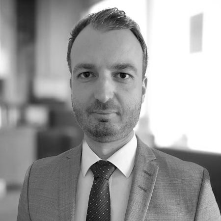 Domokos a lawyer wearing a suit and tie